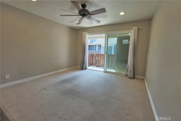 Living room with balcony and ceiling fan