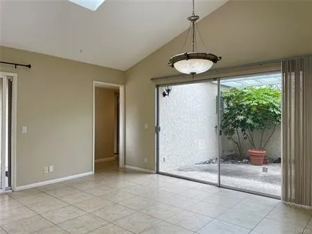 Large Family ROOM .."Great Room" with a skylight and Custom Light...Looks out on the enclosed maintenance  Backyard and ATRIUM....This room separates the Master suite to the 2 second bedrooms...