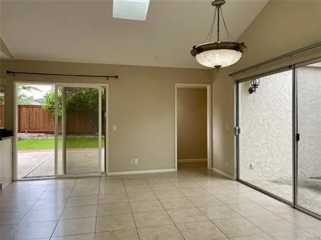 Large Family ROOM .."Great Room" with a skylight and Custom Light...Looks out on the enclosed maintenance  Backyard and ATRIUM....This room separates the Master suite to the 2 second bedrooms...