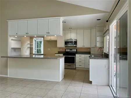 Great Open Gourmet Kitchen....Stainless Steel Sink and newer Euro Faucet....Green House window looking out on the huge enclosed  fenced Low Maintenance Yard.