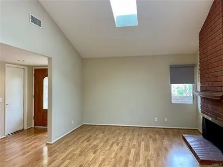 Greet your guests in the Living Room accented by a Classic brick Fireplace stretching up to the vaulted ceiling