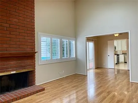 Greet your guests in the Living Room accented by a Classic brick Fireplace stretching up to the vaulted ceiling