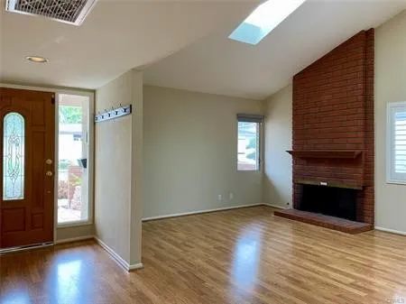 Greet your guests in the Living Room accented by a Classic brick Fireplace stretching up to the vaulted ceiling