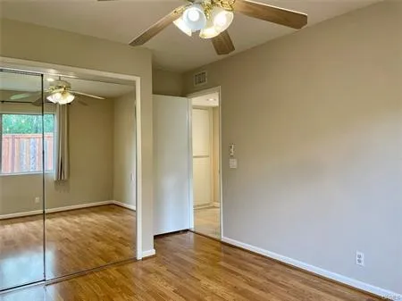 One of the second bedrooms with Mirrored wardrobes and a ceiling fan.