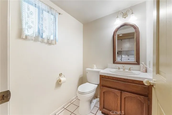 Half bathroom next to wet bar