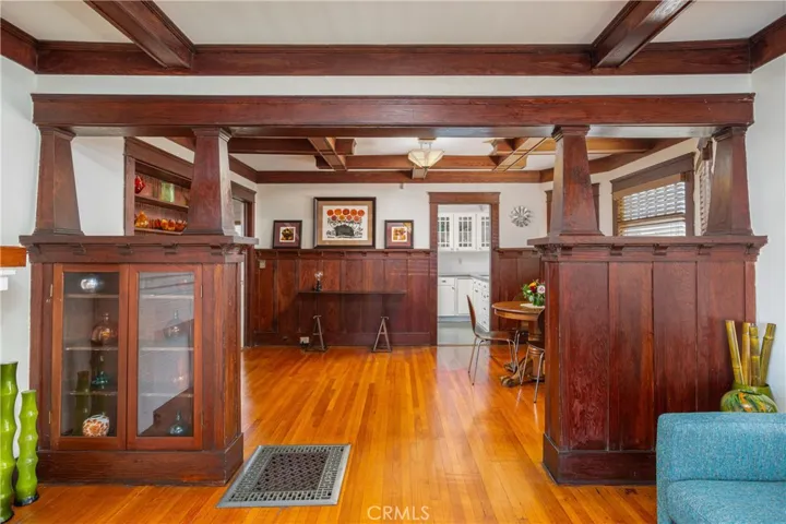 Living room with coffered ceilings and built in cabinetry