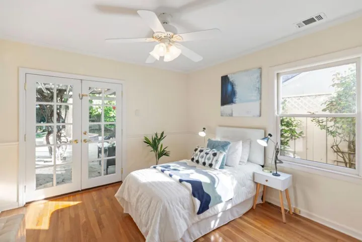 2nd bedroom with French Doors to back yard. Stairs to extra attic space are in closet