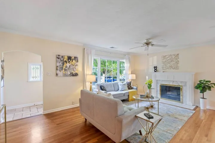 Living Room with hardwood floors and front door entryway, looks out over beautiful tree lined street