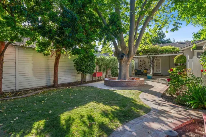 Beautifully landscaped yard with multiple areas to relax & enjoy in sun or shade