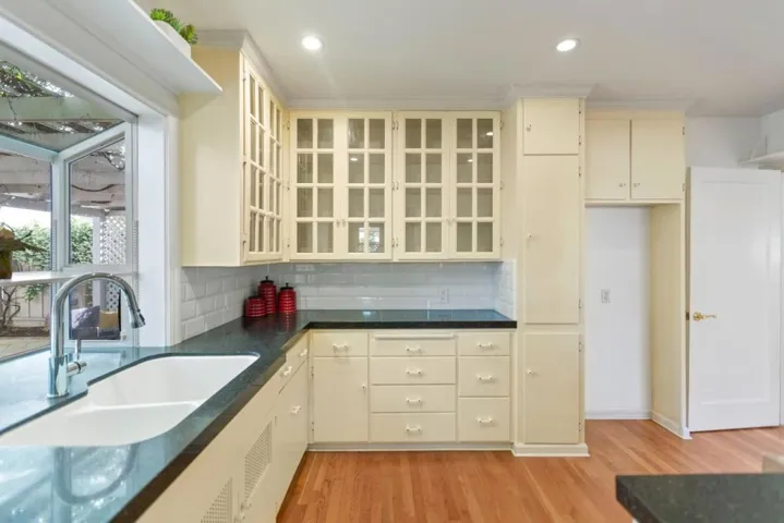 Black quartz countertops, glass cabinets and lots of storage