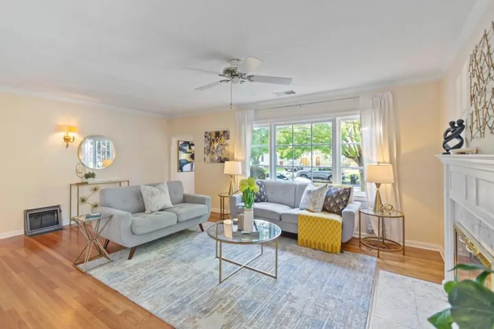 Living Room with hardwood floors and front door entryway, looks out over beautiful tree lined street