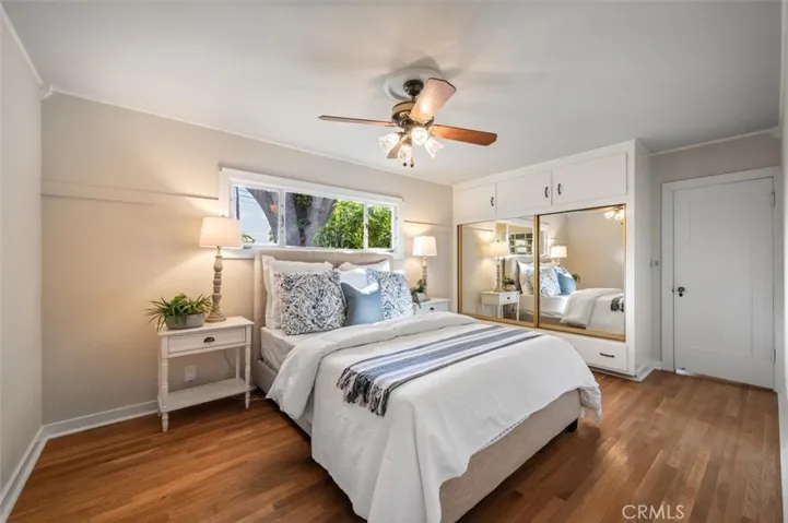 Main bedroom with mirror closet doors.