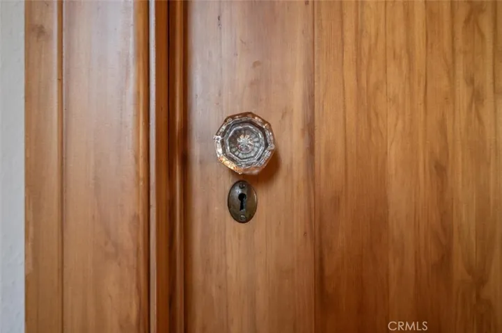 Love the soft grain red Eucalyptus "gum" wood. Note the original glass knobs.