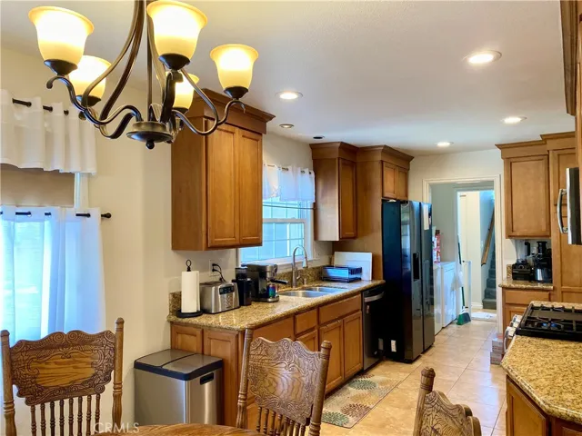 Eat-in kitchen with granite counters, gas range, newer dishwasher and refrigerator