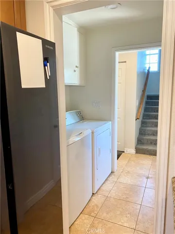 laundry room behind kitchen, then stairs leading to primary retreat, and step down to garage conversion