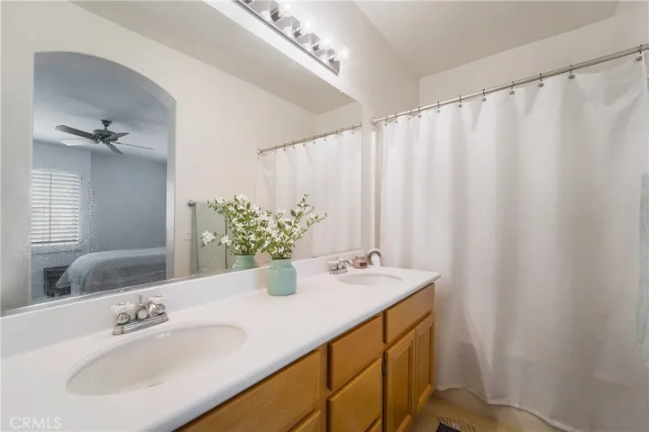 Shower, bath, dual vanities and a private stool area.