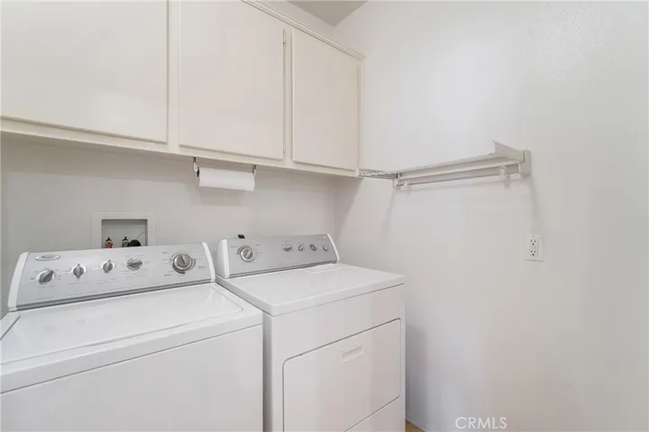 The laundry room sits next to the kitchen area and includes the washer and dryer.