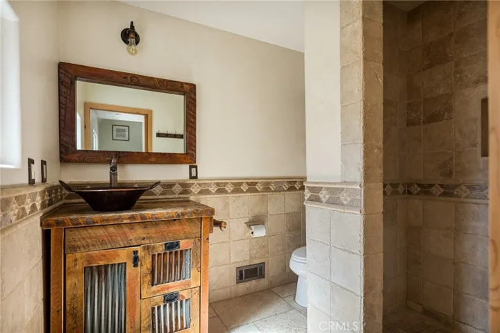 Main level 3/4 bathroom with Italian title floors and shower.