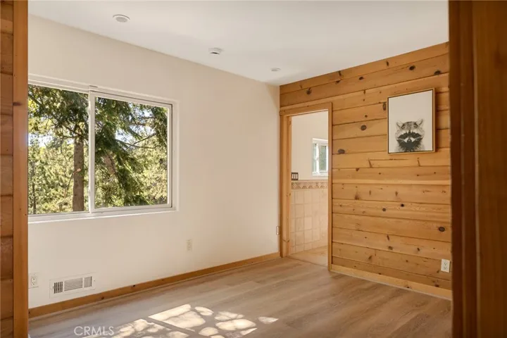 Main level bedroom with 3/4 bathroom.  Shown in its current view.