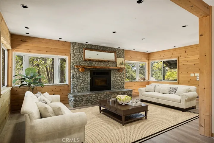 Look at all the BIG fireplace and hearth!  LVP flooring and recessed lighting. NOTE: This photo has been virtually staged to offer a preview of furniture placement, providing an insightful perspective for arranging your living space.