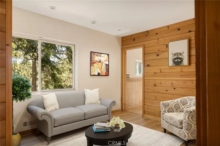 Main level bedroom ready for guest.   NOTE: This photo has been virtually staged to offer a preview of furniture placement, providing an insightful perspective for arranging your living space.