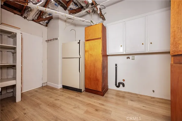 Laundry room / storage area with 2nd fridge & attic