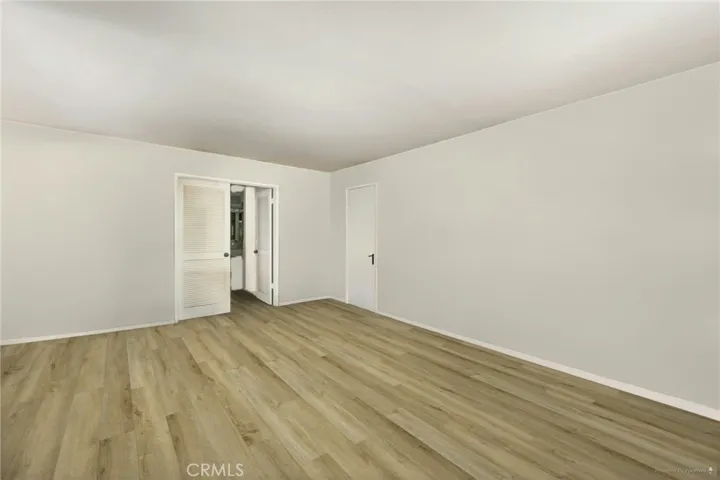 **Edited Photo** Living room reimagined with new paint and flooring.