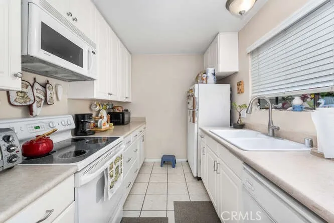 Edited photo**Kitchen and breakfast reimagined with new flooring and paint**