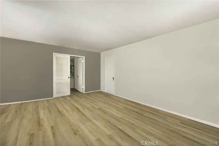 *Edited Photo* Living Room reimagined with new flooring and paint (an accent wall). *For reference only-home is occupied.