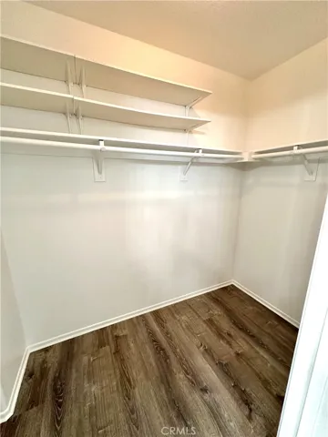 walk in Master bedroom closet freshly painted and new vinyl flooring.