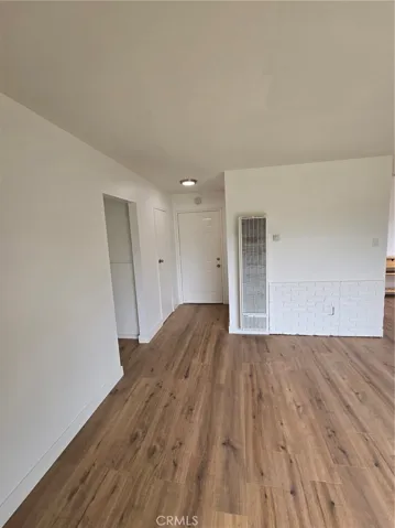 Living Room with view of hallway on left, Front Door straight ahead and separation wall (from kitchen)