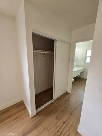 Master Bedroom with view of one of the two closets and Master bath in the distance