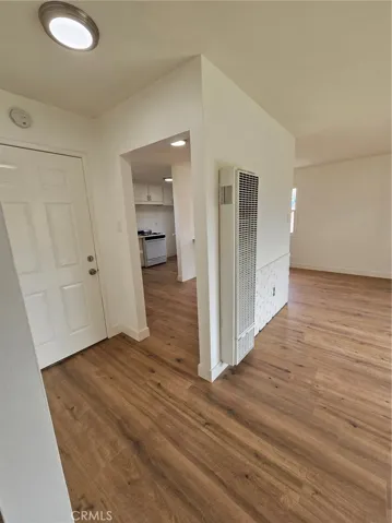 Front Door with view to kitchen and wall heater in the living room