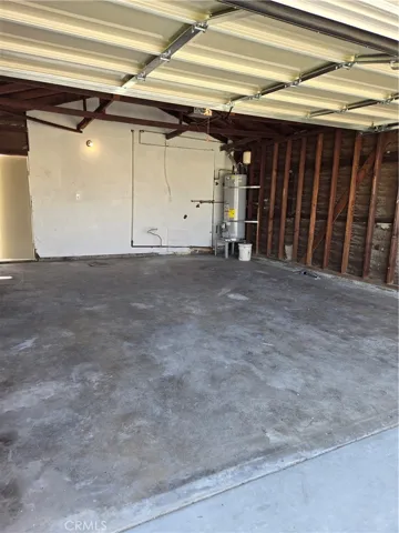 Garage...with water heater and washer/dryer hookups in view
