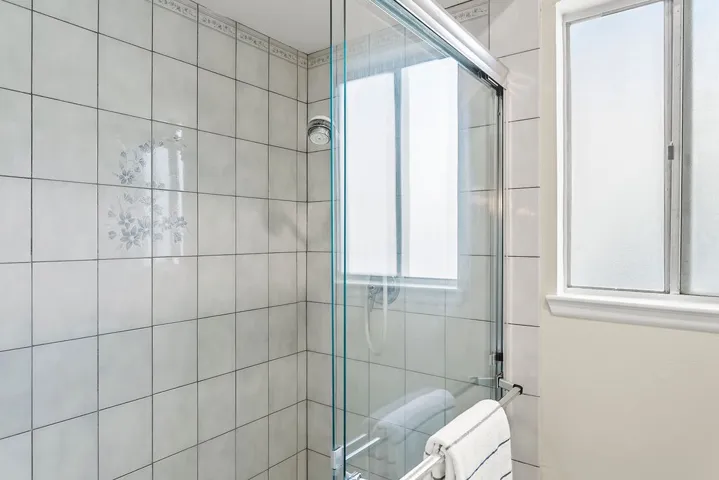 Walk in shower and commode separated from vanities