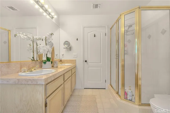 Master bathroom with double sinks and shower stall