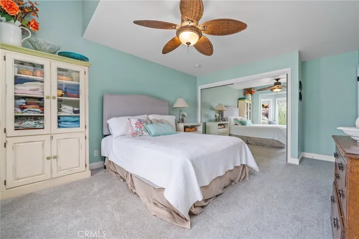The cozy secondary bedrooms are complete with carpet floors and ceiling fans.