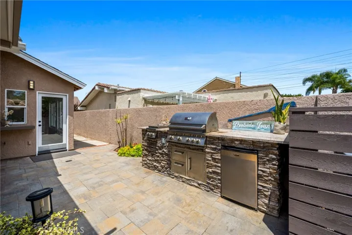The backyard features a built-in gas BBQ and outdoor fridge, making this space a private oasis for family gatherings or to just enjoy warm afternoon breezes and summer pool parties!