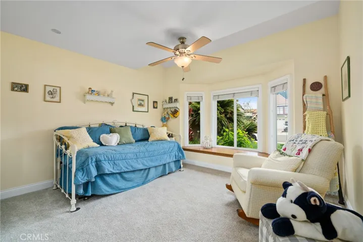 Secondary bedroom with bay windows and sitting benches for a cozy retreat.
