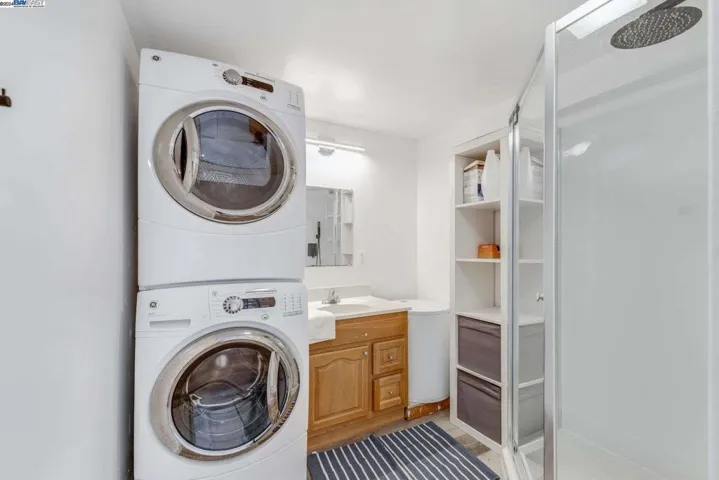 Shower with Laundry setup in the back unit.