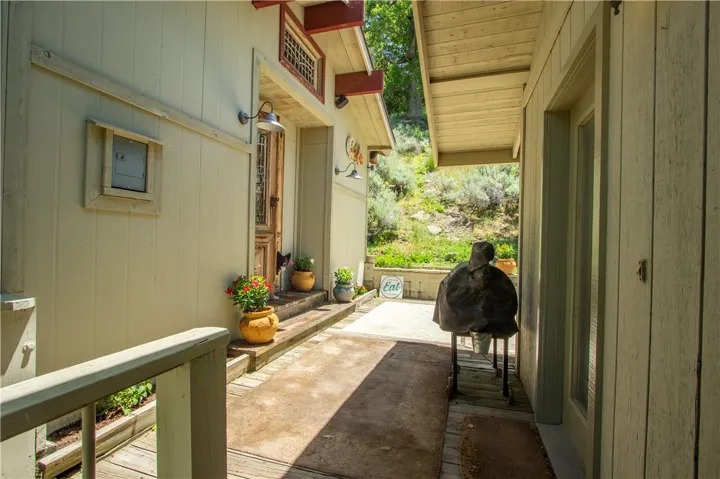 Front entrance to main house to the right and entrance to outdoor enclosed kitchen to the left,