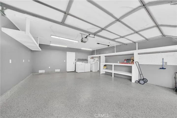Two car garage with epoxy flooring, location of washer and dryer, water heater and water softener, super clean