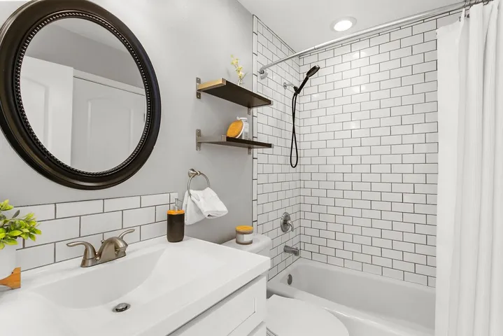 Shared full bathroom with shower over tub upstairs.