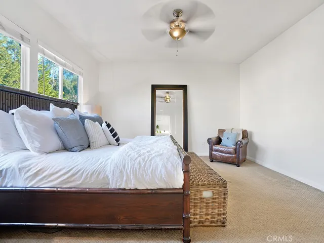Primary suite with modern ceiling fan and plenty of