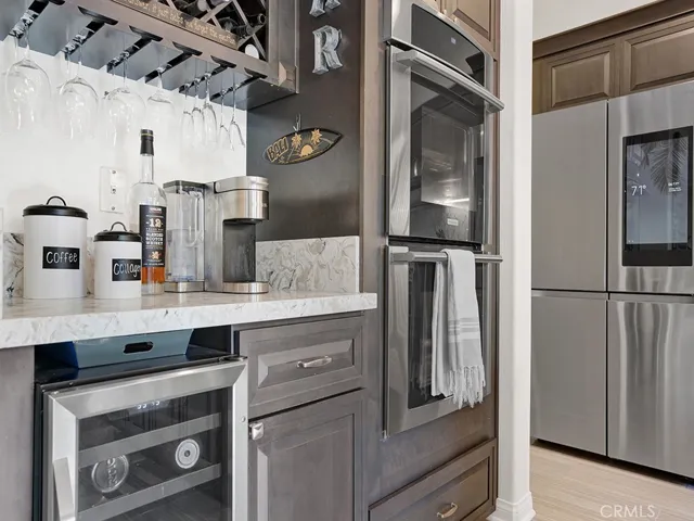 Built in dry bar complete with wine fridge, storage for your wine glasses under the cabinet, double oven!
