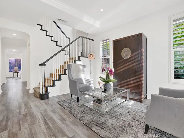 Walk in the front door to this gorgeous sitting room perfect for hanging out complete with beautiful ceiling soffit, recessed lighting, white plantation shutter, low maintenance vinyl flooring.
