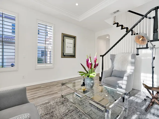 View from the corner of the sitting room out towards the stairs. Beautiful shutters and bright and light!!