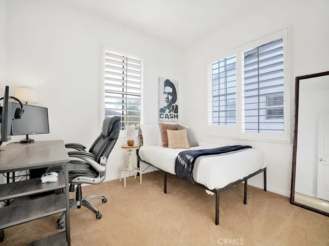 Bedroom #3 with plantation shutters, a large closet, and plush carpet.