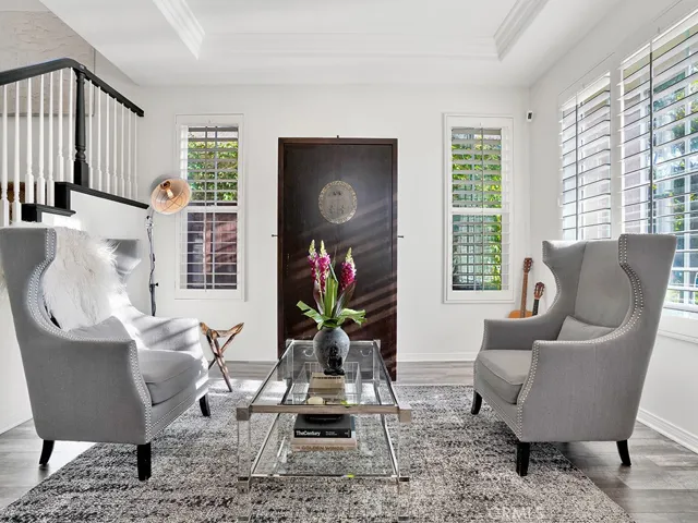 Gorgeous front room for entertaining guests complete with soffit ceiling, recessed lighting, plantation shutters, freshly painted, vinyl flooring easy to clean!