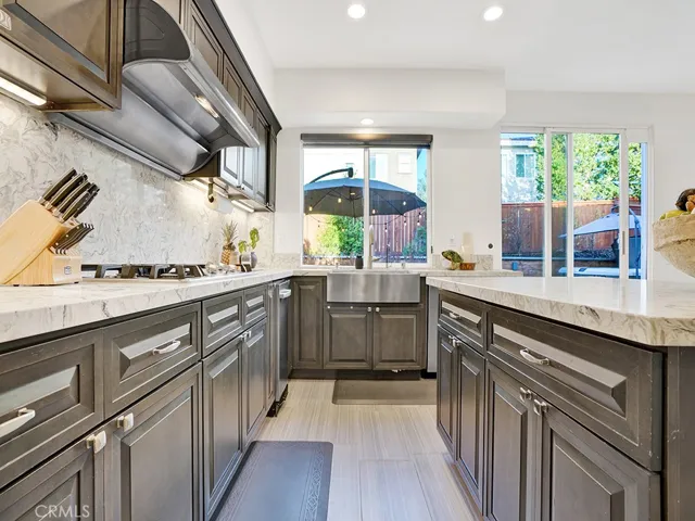 Huge is to cook with ample storage, stainless farmhouse sink making it easy to wash your large pots and pans, gas cooktop, and professional style range hood.